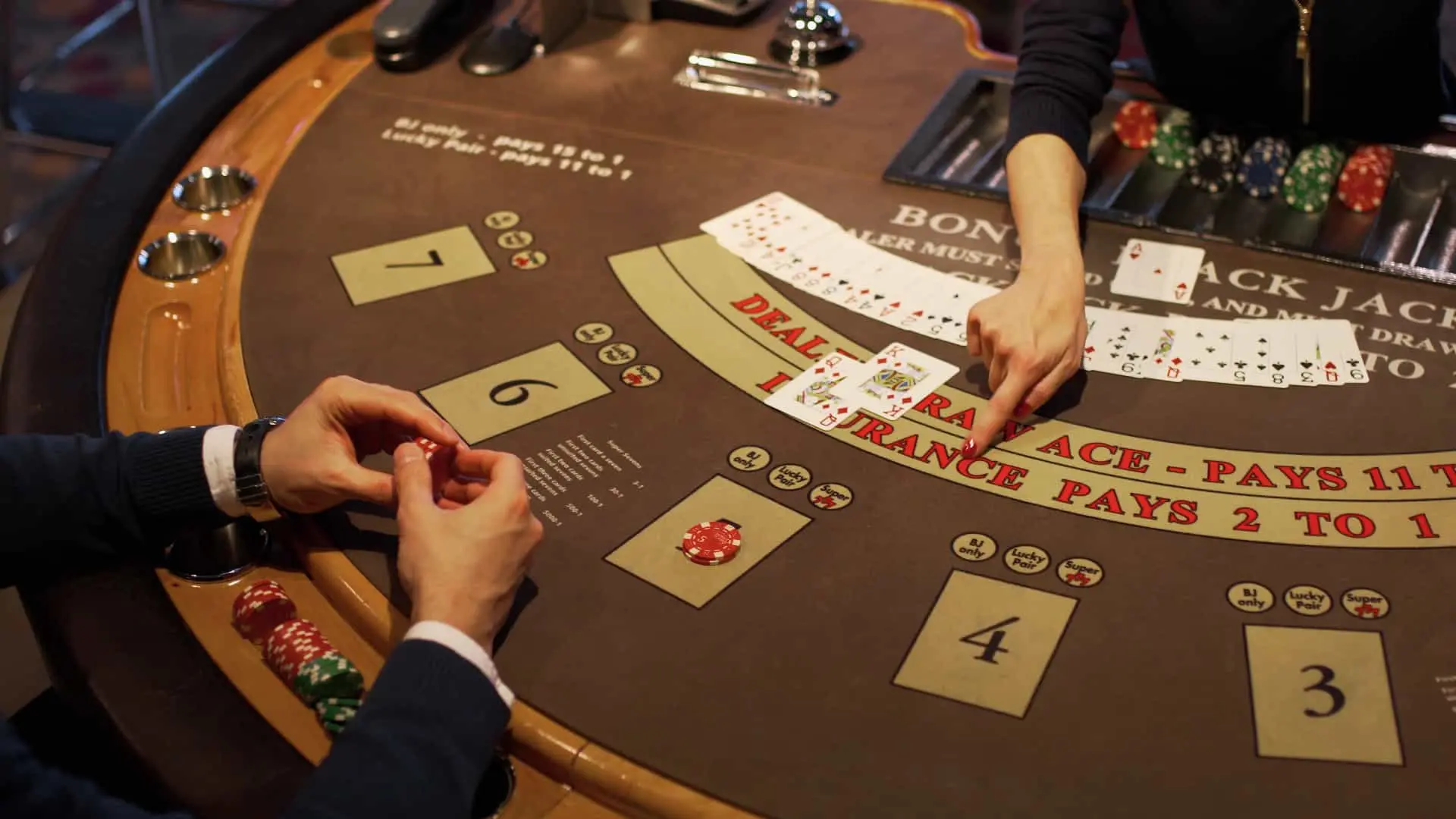 a professional gambler plays blackjack at a table